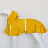 A bright yellow waterproof reflective dog raincoat displayed on a white mannequin.