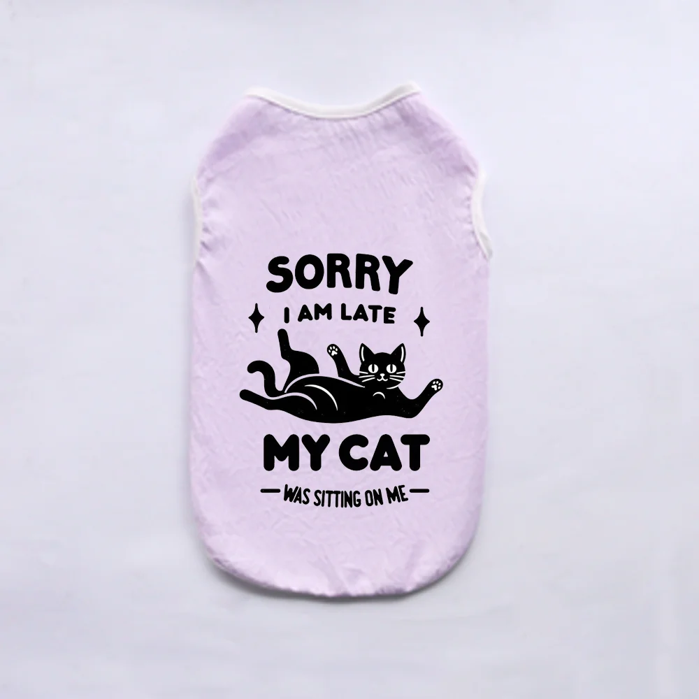 A light purple vest with black text that reads Sorry I am late My cat was sitting on me