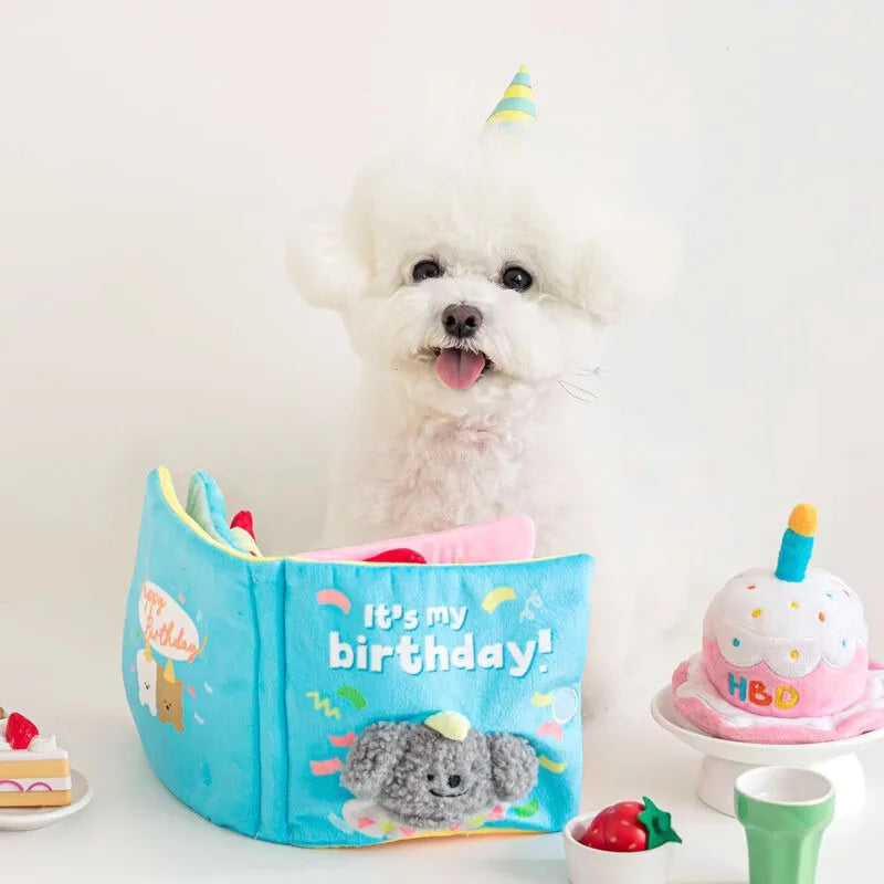 A white poodle toy is shown next to a blue interactive snuffle book toy for small dogs.