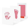 A white card with a pink handprint and footprint design next to a pink card with a rectangular cutout.