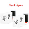 Two black baby handprint and footprint kits for keepsakes displayed on a white background.