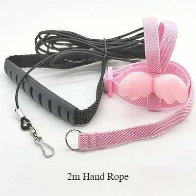 A set of pink and black adjustable bird training harness and leash rope for parrots.