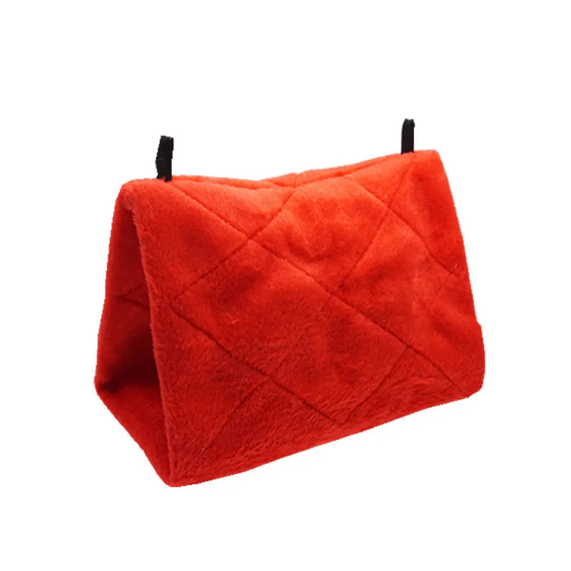 A bright red, quilted plush bird hammock tent with black strings.
