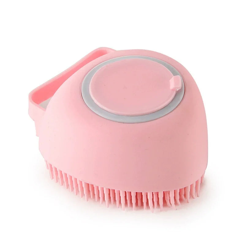 A pink silicone pet bath massage brush with a foam maker attachment.