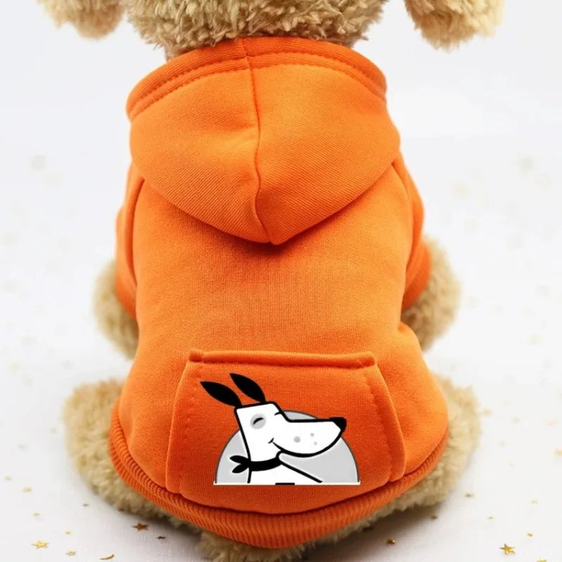 An orange cozy fleece dog sweatshirt with a hood and a pocket, featuring a cartoon face design.